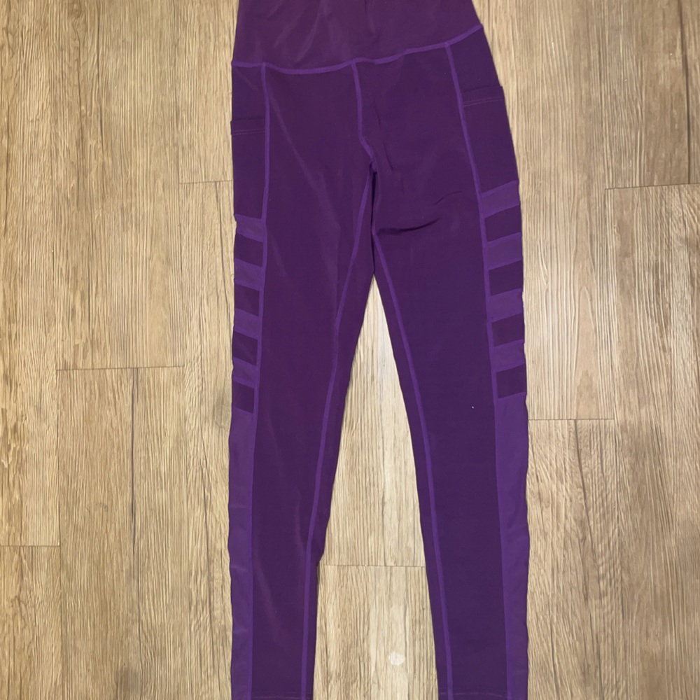 Purple leggings with mesh cutouts